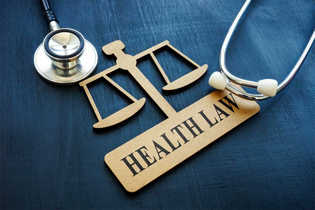 Sign with scales of justice which reads health law