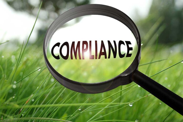 Magnifying glass highlighting the word compliance